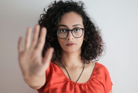 Photo by Andrea Piacquadio: https://www.pexels.com/photo/portrait-photo-of-woman-in-red-top-wearing-black-framed-eyeglasses-holding-out-her-hand-in-stop-gesture-3762802/